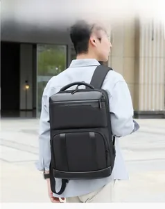 Close-up of black commuter business backpack with waterproof leather panels on a male model