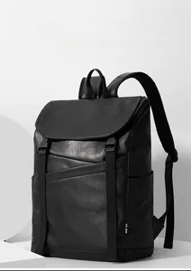 Close-up of matte black leather backpack with flap closure and dual plastic buckle straps