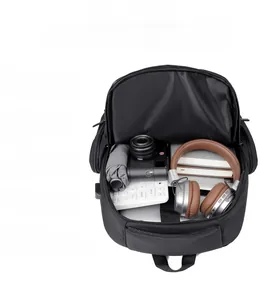 Top view of open laptop backpack with organized compartments for electronics and camera
