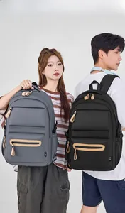 Detail showing high-density water-resistant nylon backpacks in dark grey and black colors