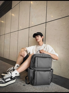 Detail of dark grey business laptop backpack with durable nylon fabric and front pockets