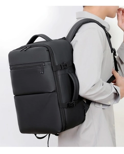 Detail of expandable black business backpack with side buckles and waterproof matte texture