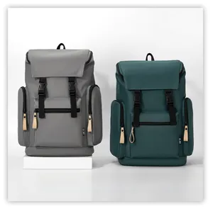 Detail view of grey and dark green backpacks with buckle straps and side zipper pockets