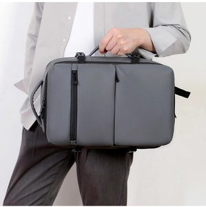 Deep grey water-resistant business backpack with side handles and minimal industrial style