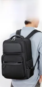 Detail of high-capacity black business backpack showing reinforced leather handles and seams