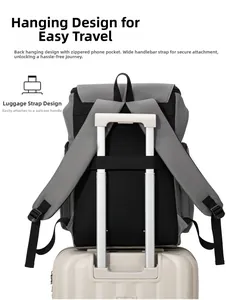 Detail of grey backpack with luggage strap secured on a suitcase handle for easy travel