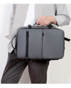 Detail view of water-resistant matte fabric and reinforced zippers on grey business backpack