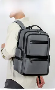Side view of dark gray oxford fabric commuter backpack on model with ergonomic shoulder straps