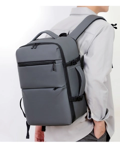 Deep grey business backpack with waterproof fabric shown on model from side view