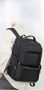 Side view of model wearing a black oxford fabric commuter backpack with leather details