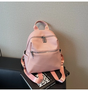 Detail of pink mini backpack with woven texture and durable nylon webbing straps