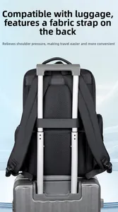 Business backpack featuring a rear luggage strap secured onto a suitcase handle