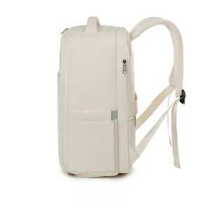 Side view of beige travel backpack with padded handle and multi-layer zippers