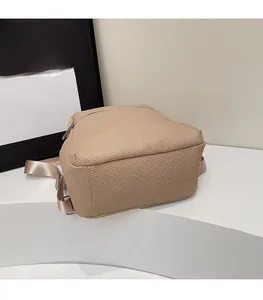 Detail view of thickened reinforced base and twill texture on a brown backpack