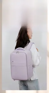 Woman wearing a lilac multifunctional travel backpack with USB charging port