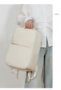Detailed view of cream minimalist waterproof travel backpack with side pocket and sleek zipper