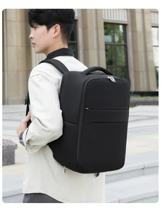 Close-up of durable black travel backpack showing thick handle and metal double zippers