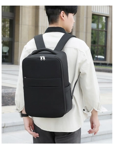 Outdoor view of a black minimalist travel backpack on a model for business commuting