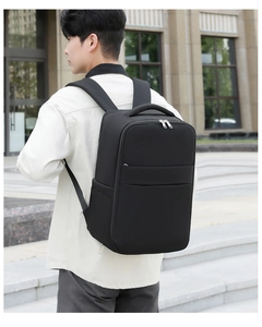 Man wearing large black business travel backpack with breathable shoulder straps