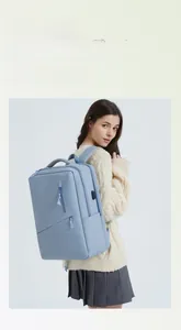 Detail of light blue laptop backpack showing side USB charging port and sleek side pocket