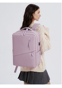 Detail view of purple laptop backpack with USB charging port and geometric zipper pockets