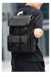 Rear view of a matte black waterproof backpack on a person for daily commuting