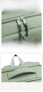 Detail view of smooth metal two-way zippers and thickened handle on light green laptop bag