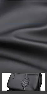 Detail of waterproof high-density fabric on black backpack highlighting matte finish