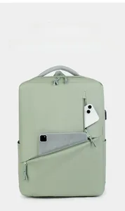 Macro shot of green laptop backpack showing external USB port and tablet storage slot