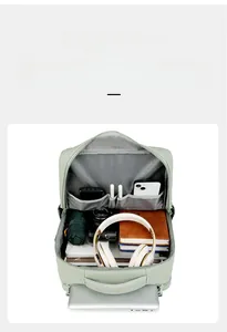 Detailed interior of mint green backpack showing organized laptop and accessory compartments