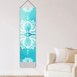 Zen style lotus print tapestry with tassels and wooden pole hanging on a white wall