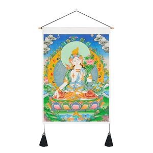 Thangka wall art featuring White Tara on lotus throne with wooden frame and black tassels