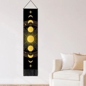 Modern moon phase tapestry with gold lunar cycle print and tassels on a white wall