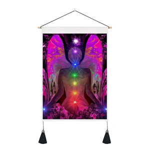 Detail of meditation tapestry with 7 chakras energy points, wooden rod and black tassels
