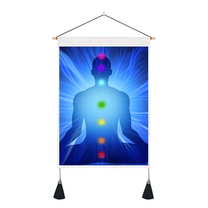 Detail of meditation wall tapestry with seven chakra silhouette and black decorative tassels