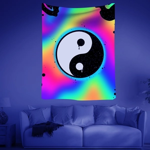 Detail of UV reactive psychedelic tapestry with melting Yin Yang symbol in neon colors