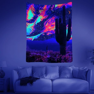 Detail of UV reactive tapestry showing neon psychedelic desert cactus and starry night sky