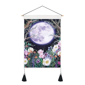 Detail of bohemian tapestry featuring a purple moon and floral night scene with tassels