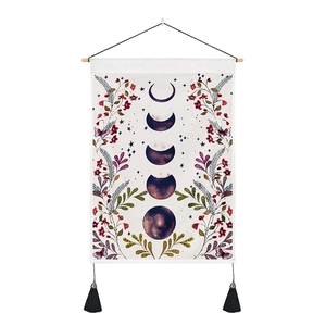 Detailed view of bohemian moon phase tapestry with floral art and elegant black tassels