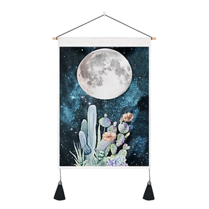 Detail of bohemian moonlit tapestry with soft desert plants and black tassels