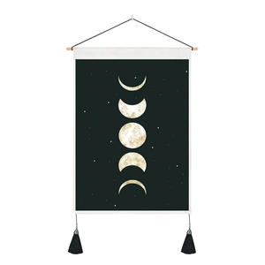 Detailed view of bohemian moon phase tapestry with gold frosted texture and black tassels