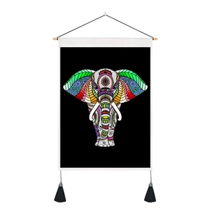 Detail of modern boho elephant wall hanging with colorful mandala patterns and tassels