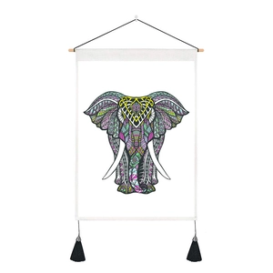 Close-up of bohemian colorful elephant mandala tapestry with wooden rod and black tassels