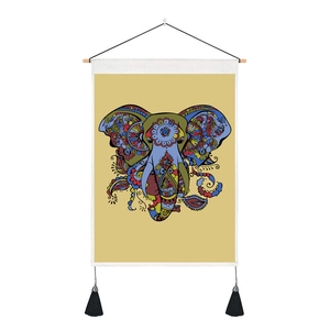 Detailed view of colorful elephant canvas tapestry with wood hanging rod and black tassels