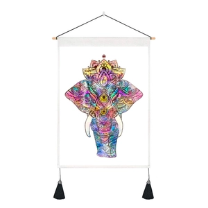 Detail of colorful watercolor elephant tapestry with bohemian mandala patterns and tassels