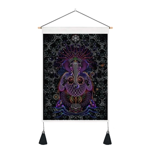 Detail of artistic elephant wall hanging with vibrant colors and black decorative tassels