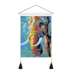 Detail of colorful elephant canvas tapestry with wooden rod and black tassel decor