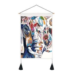 Detail of artistic elephant tapestry with wooden pole and black hanging tassels