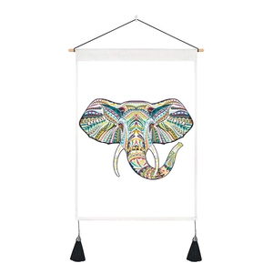 Detail of colorful elephant tapestry with bohemian geometric patterns and black tassels