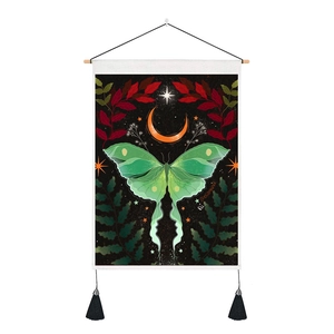 Detail of Nordic luna moth tapestry featuring green moth, moon, and black tassels